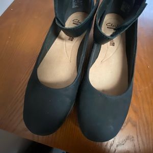 Clark flats, strap around the ankle closed with Velcro